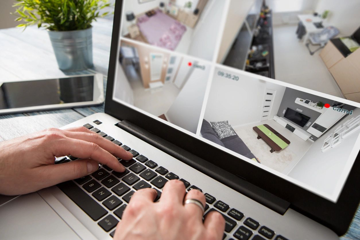 A person is typing on the keyboard of their laptop.